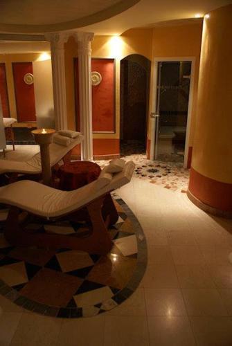 a living room with a room with a couch and a table at Hotel Lady Mary in Milano Marittima
