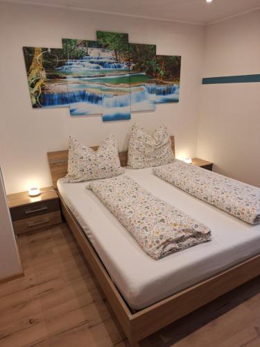 a bedroom with two beds and a painting on the wall at Ferienhaus Melchartboden in Paal