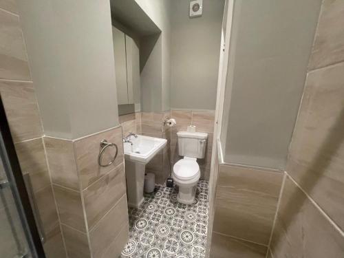 a small bathroom with a toilet and a sink at Central Hotel in Norwich