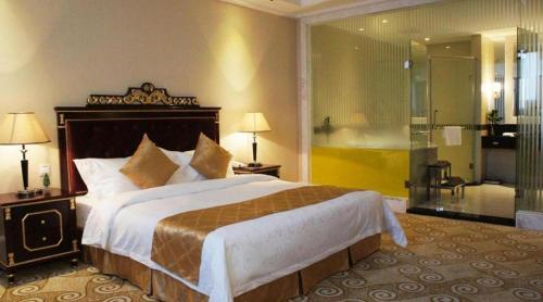 a bedroom with a large bed and a shower at Guangzhou Jing Yi hotel in Huadu