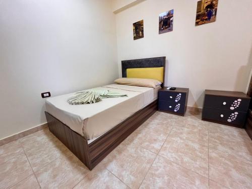 a bedroom with a bed and two night stands at Reef House in Marsa Alam City