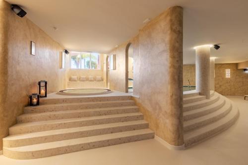 a staircase in a room with concrete walls at Belavista Da Luz - Wellness & Lifestyle Hotel in Luz