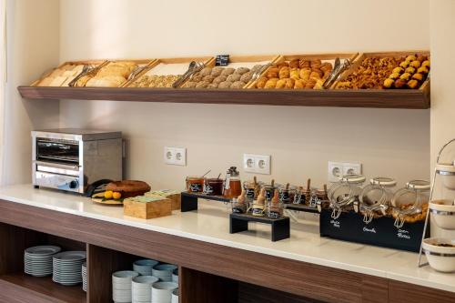 a bakery with bread and pastries on a counter at Belavista Da Luz - Wellness & Lifestyle Hotel in Luz