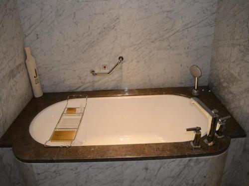 a bath tub with a faucet in a bathroom at Xian Jue Vu Hotel in Xi'an