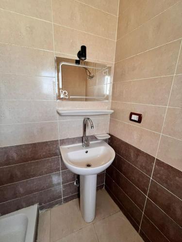 a bathroom with a sink and a mirror at Reef House in Marsa Alam City