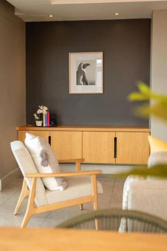 a living room with a couch and a chair at Ocean Family Deluxe, Hermanus Waterfront - Apt 2 in Hermanus