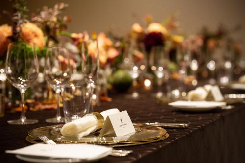 a table with a plate of food and wine glasses at The Ritz-Carlton Kyoto in Kyoto