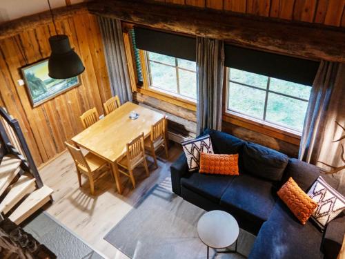 ein Wohnzimmer mit einem Sofa und einem Tisch in der Unterkunft Holiday Home Vuokatinportti a 12 by Interhome in Lahdenperä