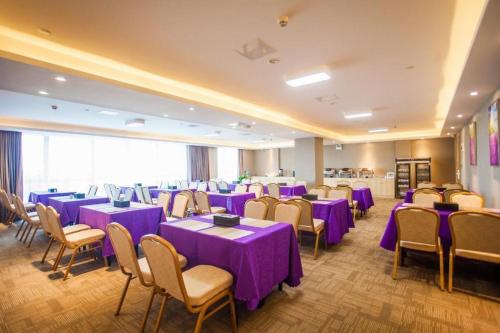 a banquet hall with purple tables and chairs at Lavande Hotel Zhaoqing government Dinghu Mountain Scenic Spot in Zhaoqing