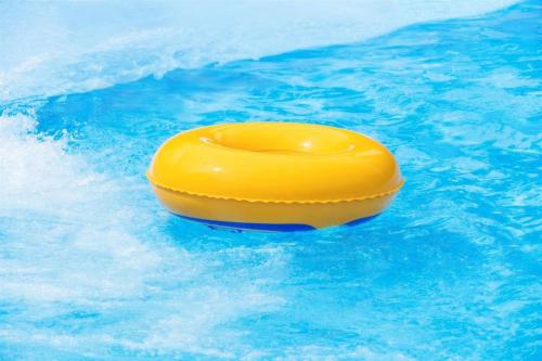 a yellow raft in the water in a pool at Labersa Grand Hotel &Convention Center in Pekanbaru