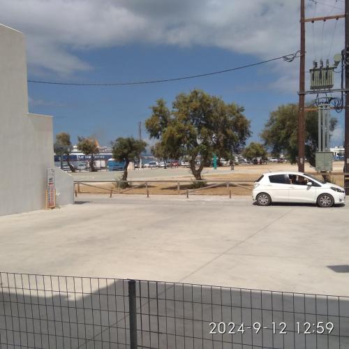 a white car parked in a parking lot at Katy's Home in Naxos Chora