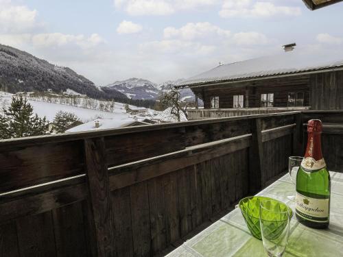 a bottle of wine on a table with a glass at Apartment Jaggler by Interhome in Dorf