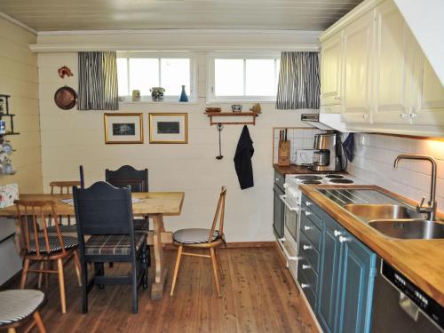 a kitchen with a table and a dining room at Holiday Home Ørviksnes by Interhome in Steinstø