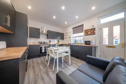 a kitchen with a table and a dining room at RAA12s For your relaxed and Cosy stay with Free Parking in Headingley