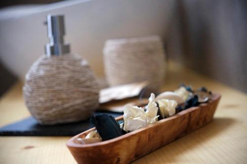 a wooden bowl of food sitting on a table at Ca' Brazzo Bed Relais in Pontecasale