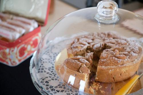 a cake on a glass plate on a table at Ca' Brazzo Bed Relais in Pontecasale