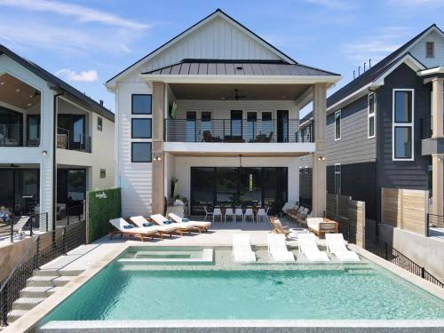 a house with a swimming pool in front of a house at The Enclave New Listing Concierge Services in Kingsland