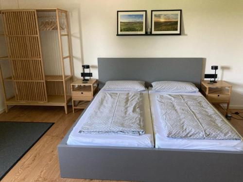a bedroom with two beds and two night stands at Appartement Willems in Konz