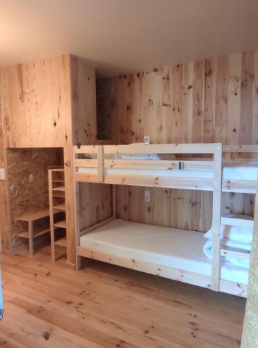 a room with four bunk beds in it at Gîte Le Lustou in Cadéac
