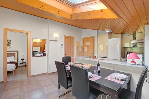 a kitchen and dining room with a table and chairs at El Tarter Spacious Ski Apartment - Happy Rentals in El Tarter