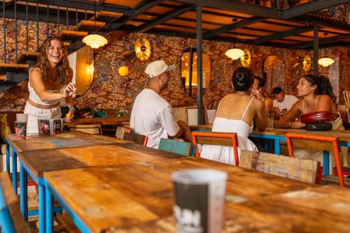 a group of people sitting at tables in a restaurant at Villa Saint Exupery Beach Hostel in Nice