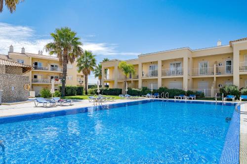 a large swimming pool in front of a building at Albufeira Palm Tree With Pool by Homing in Albufeira