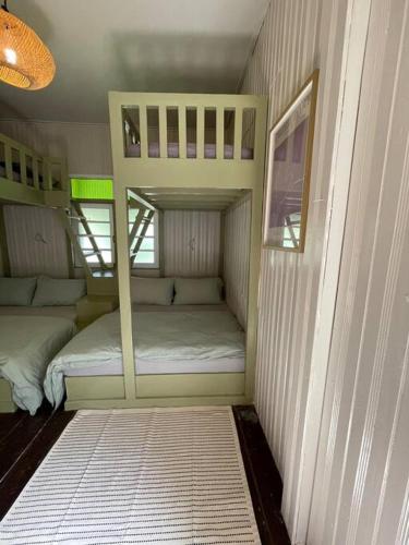 a small room with two bunk beds in it at Kapas View, Zaki's Residence, Marang, Terengganu in Kampong Ru Lima