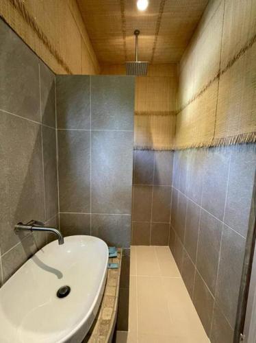 a bathroom with a white sink and a tub at Kapas View, Zaki's Residence, Marang, Terengganu in Kampong Ru Lima