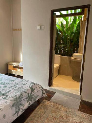 a bedroom with a door to a bathroom with a mirror at Kapas View, Zaki's Residence, Marang, Terengganu in Kampong Ru Lima