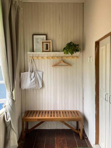 a wooden bench sitting in a corner of a room at Kapas View, Zaki's Residence, Marang, Terengganu in Kampong Ru Lima