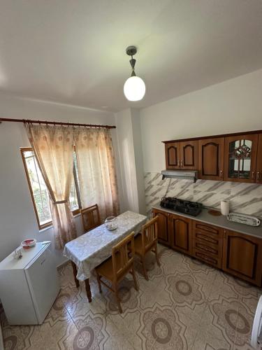 a kitchen with a table and a sink and a table and chairs at Gafko Apartments Durres in Durrës