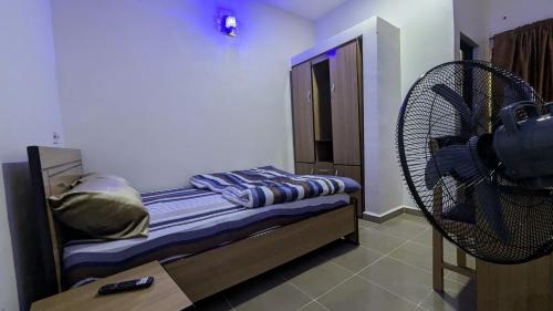 a bedroom with a bed and a fan at Nexcon Apartments in Uyo