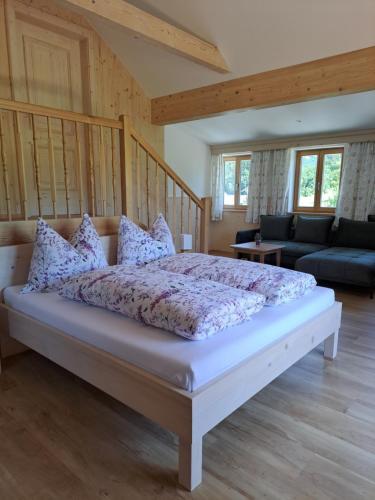 a bedroom with a large bed with pillows at Ferienhof Brunbacher Wolfgangsee in St. Wolfgang