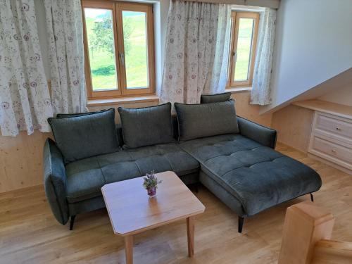 a living room with a couch and a table at Ferienhof Brunbacher Wolfgangsee in St. Wolfgang