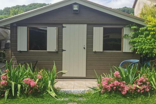 a house with a garage with two windows and flowers at Les Galipes in Avize