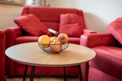 a bowl of fruit on a table in a living room at Landhaus Gabriele in Filzmoos