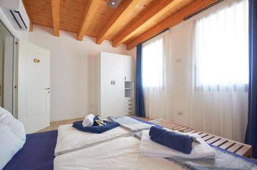 a bedroom with a large bed with towels on it at Ca' Brazzo Bed Relais in Pontecasale