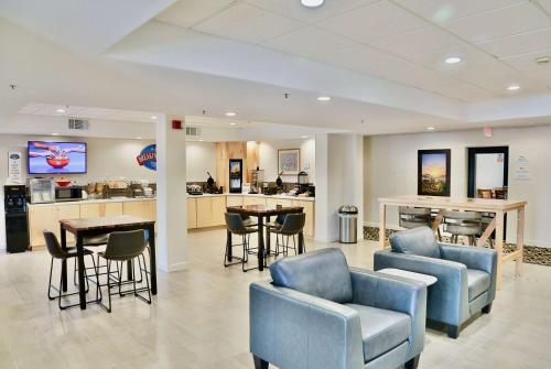 a waiting room with blue chairs and a counter at Baymont by Wyndham Tucson Airport in Tucson