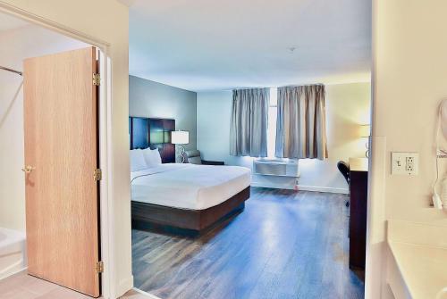 a hotel room with a bed and a bath tub at Baymont by Wyndham Tucson Airport in Tucson