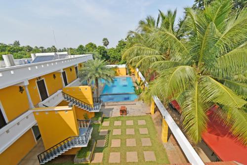 an aerial view of a resort with a swimming pool at Poppys Olive de' villa in Auroville