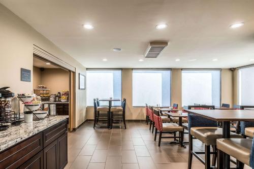 a restaurant with tables and chairs and windows at Comfort Inn Detroit Downtown in Detroit