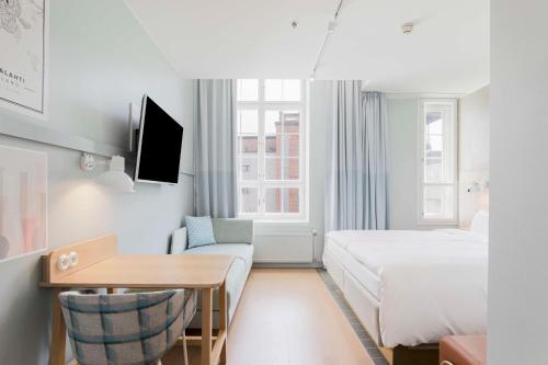 a hotel room with a bed and a desk at Radisson Blu Seaside Hotel, Helsinki in Helsinki