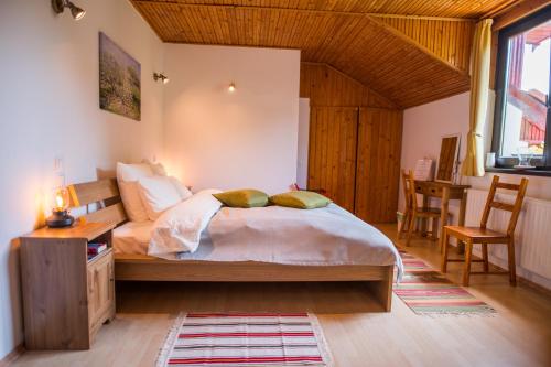 une chambre avec un lit, une table et des chaises dans l'établissement Casa din Plai, à Proviţa de Sus