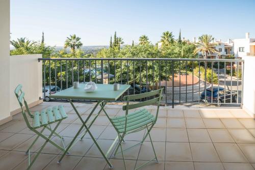 a table and chairs on a balcony with a view at Portimao Elegant House With Pool by Homing in Portimão