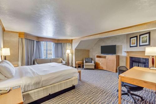 a hotel room with a bed and a desk at Radisson Hotel Salt Lake City Airport in Salt Lake City