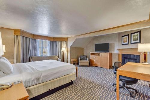 a hotel room with a large bed and a desk at Radisson Hotel Salt Lake City Airport in Salt Lake City