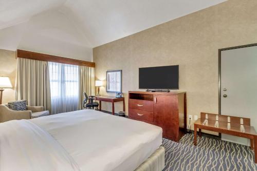 a hotel room with a bed and a flat screen tv at Radisson Hotel Salt Lake City Airport in Salt Lake City