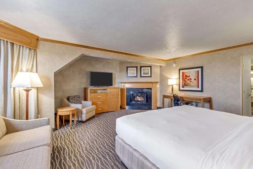 a hotel room with a large bed and a television at Radisson Hotel Salt Lake City Airport in Salt Lake City