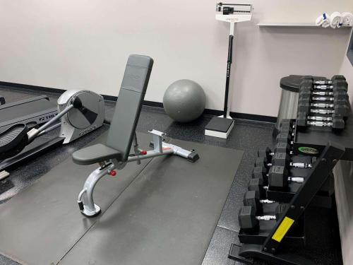 a gym with a chair and a ball on the floor at Country Inn & Suites by Radisson, Jacksonville West, FL in Jacksonville