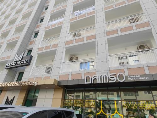 a building with a sign on the front of it at OYUSTAY Clark Terrace condo Staycation with 2 beds near airport HANN CASINO in Fort Stotsenburg